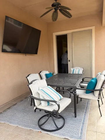 a dining room with furniture and wooden floor