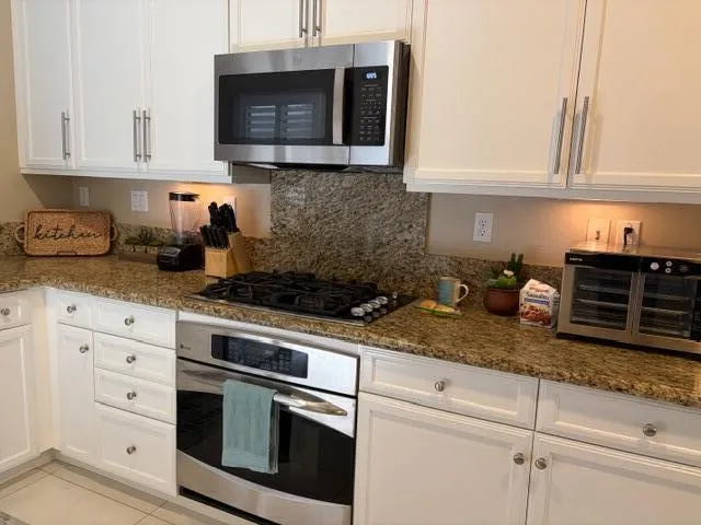 a kitchen with appliances cabinets and a counter top space