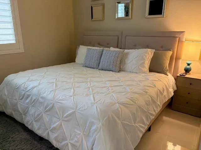 a bedroom with a bed and window