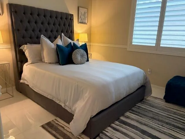 a bedroom with a bed and window