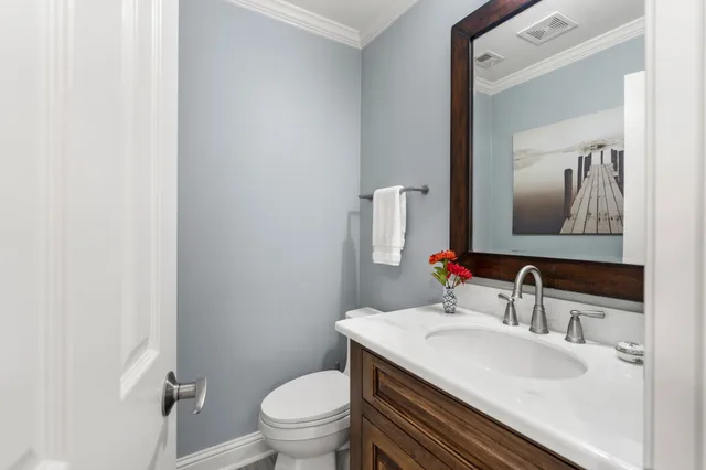 a bathroom with a sink toilet and mirror