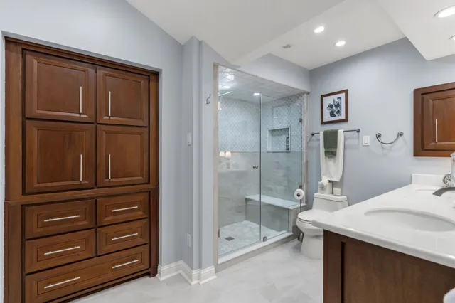 a bathroom with a shower sink and mirror