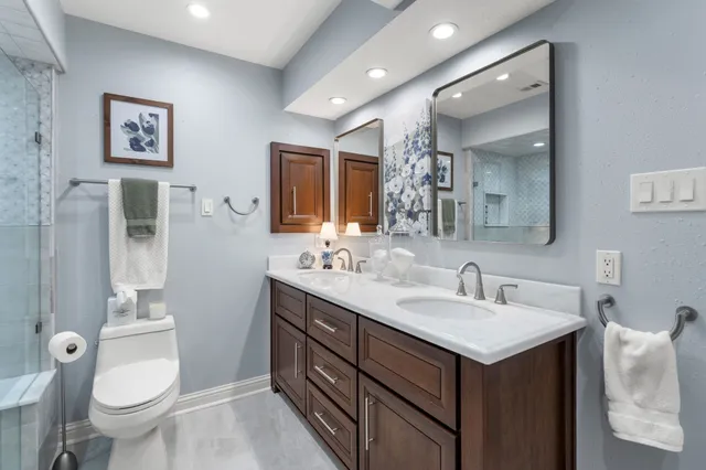 a bathroom with a toilet sink and mirror