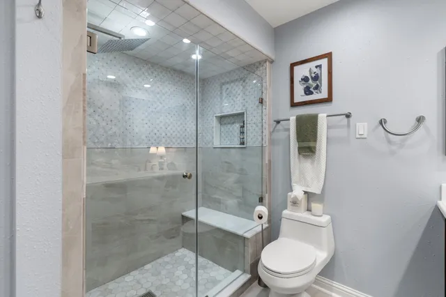 a bathroom with a toilet sink and shower