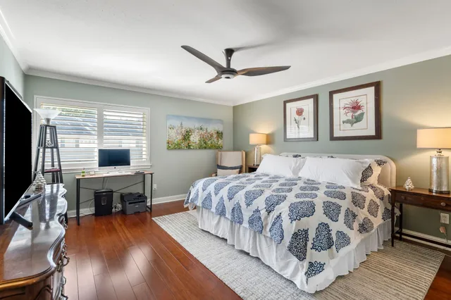 a spacious bedroom with a bed and a flat screen tv