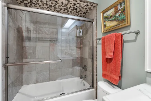 a bathroom with a bathtub and a shower