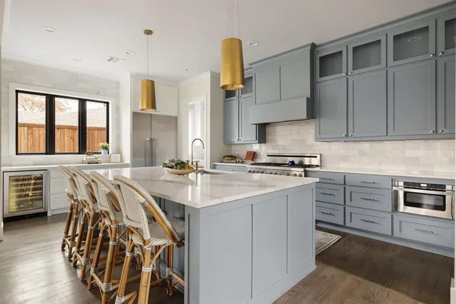 a kitchen with stainless steel appliances kitchen island granite countertop a sink and cabinets