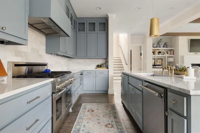 a kitchen with a sink stove and cabinets
