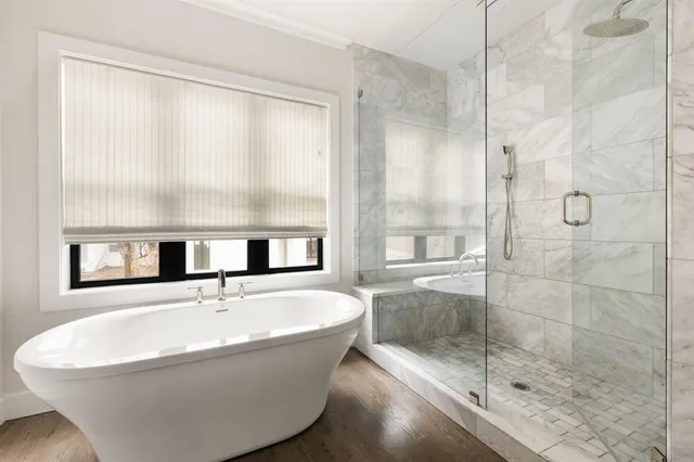 a white bath tub sitting next to a window