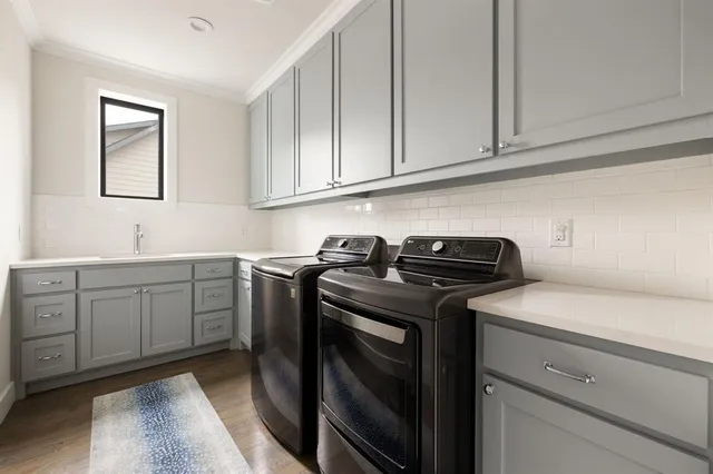 a utility room with sink dryer and washer