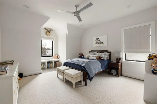 a spacious bedroom with a bed and a window