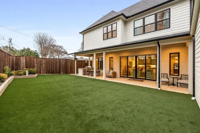 a view of an house with backyard and porch