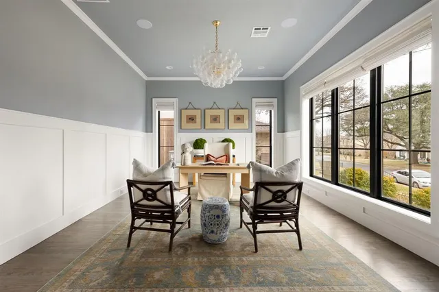 a living room with furniture a chandelier and a large window