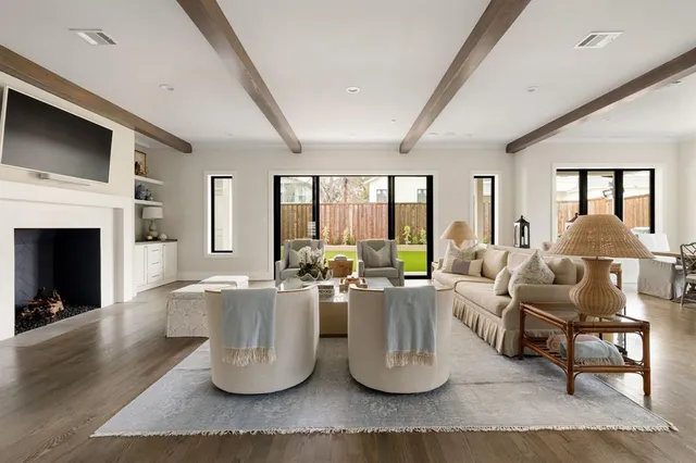 a living room with fireplace furniture and a large window