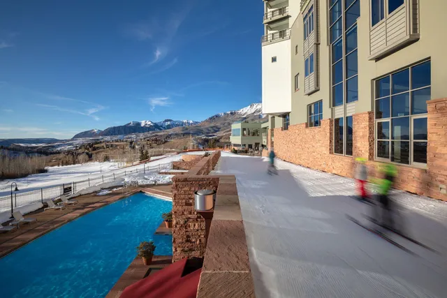 a view of a swimming pool with outdoor seating