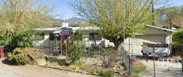 a view of a house with a tree
