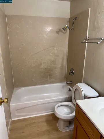 a bathroom with a toilet and a bathtub