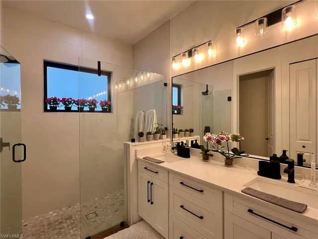 a bathroom with a sink vanity and mirror
