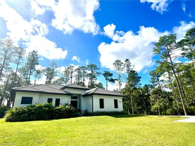 a view of house with outdoor space garden and tree s