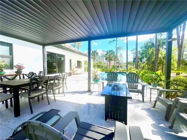 a view of a patio with a table chairs and a table