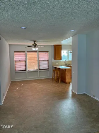 a living room with kitchen island granite countertop furniture and a fireplace