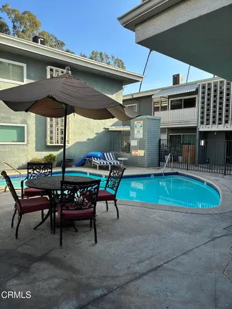 a view of a house with a backyard and a patio