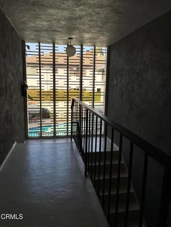 a view of a room with wooden floor and a window