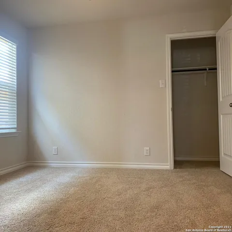 an empty room with windows and closet