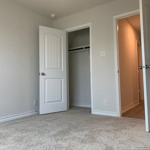 an empty room with closet area