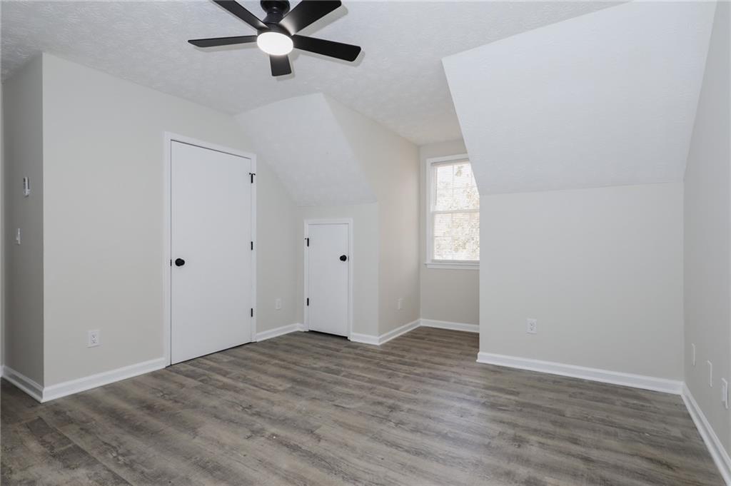 5343 Ridgemere Court Stone Mountain, GA 30083 - Photo 12 of 20 wooden floor in an empty room with a window