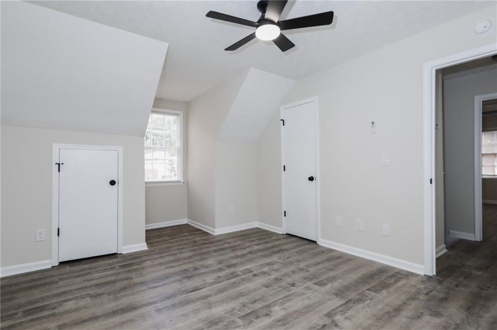 5343 Ridgemere Court Stone Mountain, GA 30083 - Photo 14 of 20 an empty room with wooden floor closet and windows