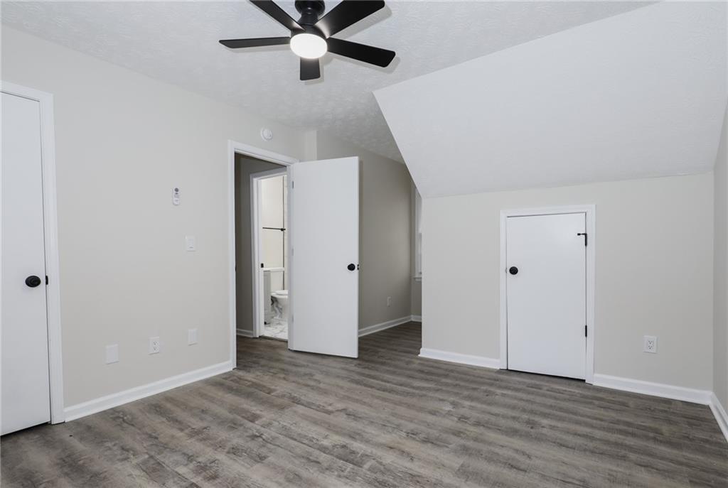 5343 Ridgemere Court Stone Mountain, GA 30083 - Photo 15 of 20 an empty room with wooden floor and ceiling fan