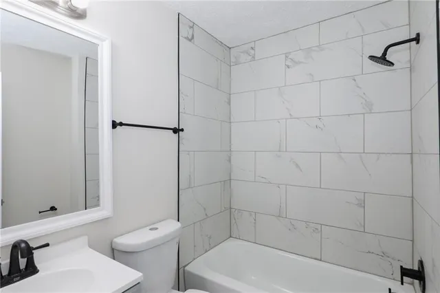 a bathroom with a bathtub and a toilet