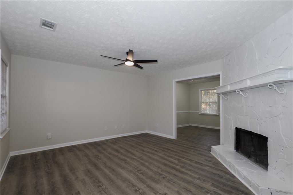 5343 Ridgemere Court Stone Mountain, GA 30083 - Photo 2 of 20 wooden floor in an empty room with a fireplace