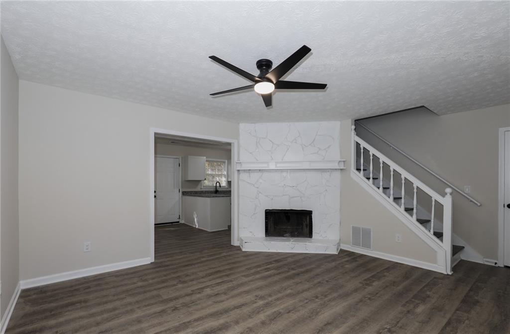 5343 Ridgemere Court Stone Mountain, GA 30083 - Photo 3 of 20 a view of an empty room with wooden floor and a kitchen