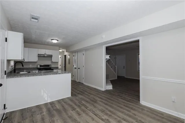 a kitchen with stainless steel appliances a refrigerator and a stove top oven
