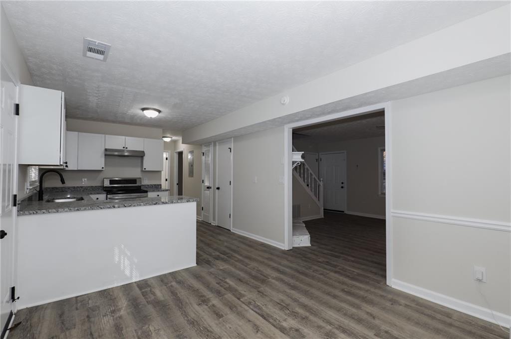 5343 Ridgemere Court Stone Mountain, GA 30083 - Photo 6 of 20 a kitchen with stainless steel appliances a refrigerator and a stove top oven