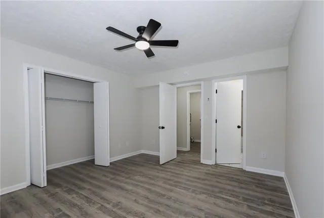 a view of a livingroom with wooden floor and white walls