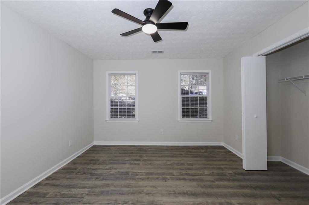 5343 Ridgemere Court Stone Mountain, GA 30083 - Photo 10 of 20 a view of an empty room with wooden floor and a window