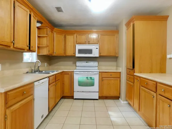 a kitchen with a refrigerator and a sink