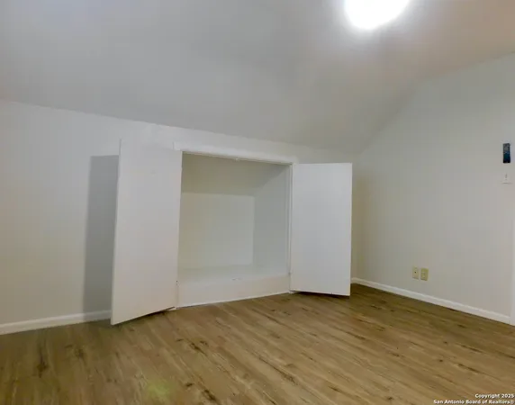 a view of an empty room and wooden floor