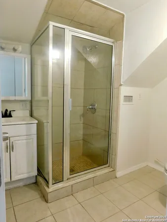 a bathroom with a shower and a sink