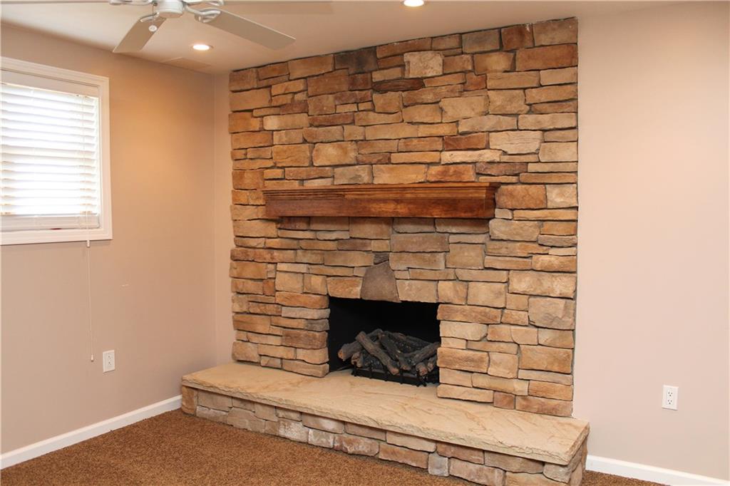 558 Partridge Run Road Gibsonia, PA 15044 - Photo 16 of 24 Stunning stone gas log fireplace in lower level game room.