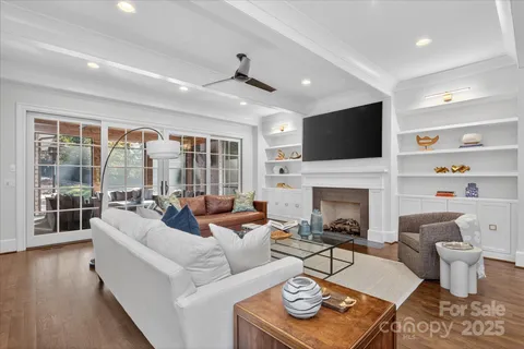 a living room with furniture a fireplace and a flat screen tv