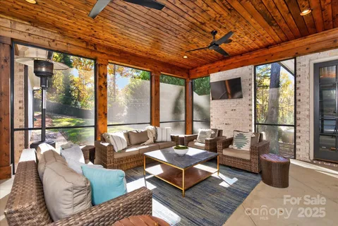 a living room with furniture and a floor to ceiling window