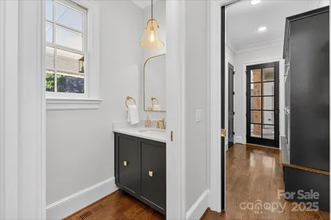 a view of hallway with sink and wooden floor