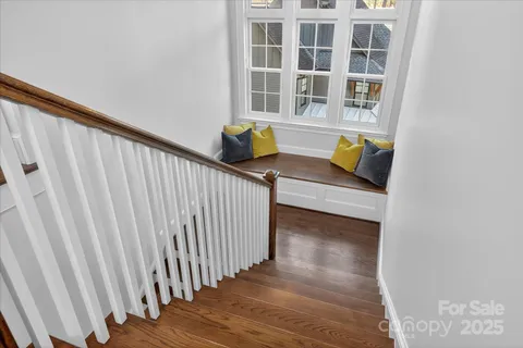 a view of staircase with wooden floor and stairs