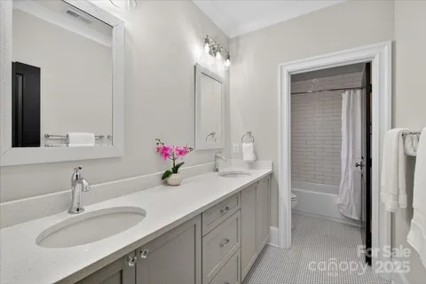a bathroom with a sink double vanity and a mirror