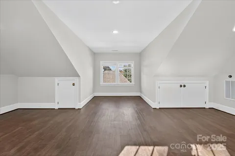 an empty room with wooden floor and window