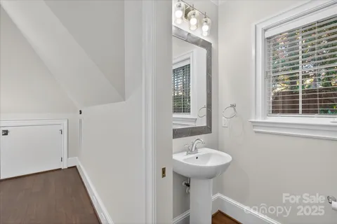 a bathroom with a sink a window and a mirror